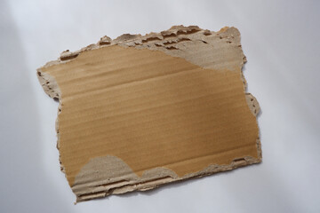 ripped cardboard piece paper note. damage cardboard for background.