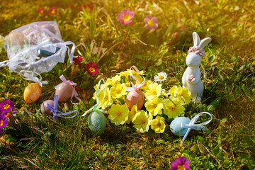 Easter bunny with Easter eggs on the grass at Easter.