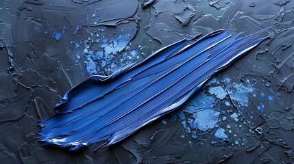 Blue oil paint smear on dark blue textured background.