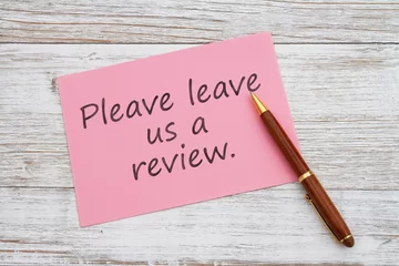 Foto op Plexiglas  Please leave us a review pink greeting card with pen on wood © Karen Roach
