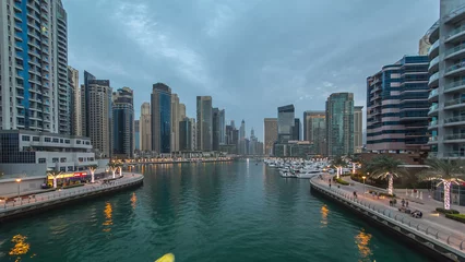 Fotobehang Evening Dubai marina city center with floating vessels day to night timelapse © neiezhmakov