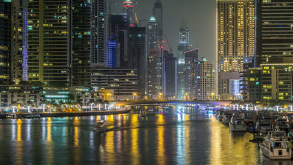 Fototapeta premium Promenade in Dubai Marina timelapse at night, UAE.