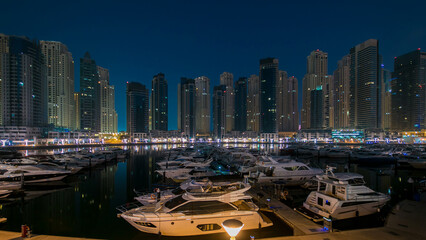 Dubai Marina at Blue hour night to day timelapse with yachts