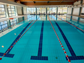 Empty pool room for professional swimming lessons on a sunny summer day