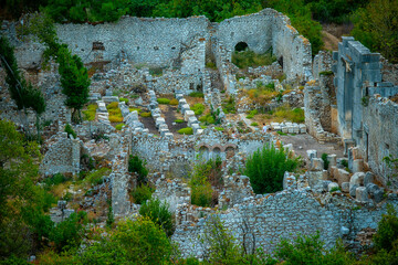 ruins of an ancient fortress in the green mountains.
The ancient city of Olympos is an ancient city at the mouth of a small river flowing into the Mediterranean Sea in Cirali Bay in Turkey.