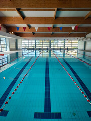 Empty pool room for professional swimming lessons on a sunny summer day