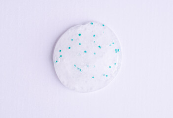 Cosmetic texture, cleanser foam, shower gel close-up on a white background. Peeling swatch. Samples of natural cosmetics, top view.