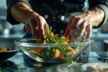 Poster With precision and care, the chef arranges fresh ingredients in a glass bowl, creating a visually stunning salad for the upscale restaurant © Milos
