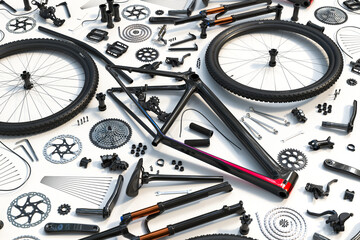 Comprehensive Display of Disassembled Bicycle Parts on a Pristine White Surface