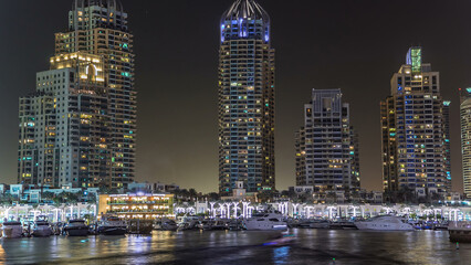Fototapeta na wymiar Promenade and canal in Dubai Marina timelapse at night, UAE.