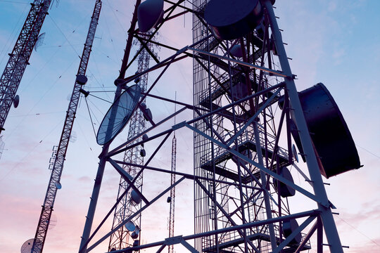 Twilight Hues Enveloping a Communications Tower Laden with Antennas