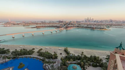 Rolgordijnen Jumeirah Palm island skyline day to night timelapse in Dubai, UAE. © neiezhmakov