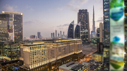 Downtown Dubai towers day to night timelapse. Aerial view of Sheikh Zayed road with skyscrapers...