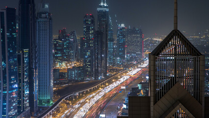 Modern skyscrapers and busy evening highways night timelapse in luxury Dubai city, Dubai, United...