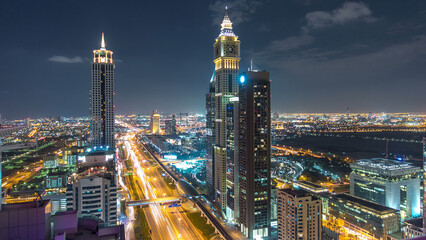 Fototapeta na wymiar Dubai downtown architecture night timelapse. Top view over Sheikh Zayed road with illuminated skyscrapers and traffic.