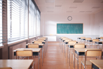 Sunlight-Infused Modern Classroom with Wooden Desks and Chalkboard