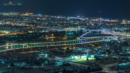 Fototapeta premium Dubai canal timelapse as seen during night with boats already crossing it.