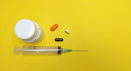 injection pill medicine bottle on a yellow background