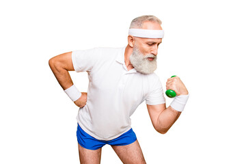 Obraz premium Body care, hobby, weight loss lifestyle. Cool grandpa with confident grimace exercising holding equipment up, lifts it with strength and power, wearing blue sexy shorts, show legs