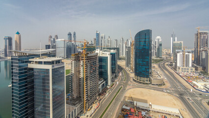 Naklejka na ściany i meble Dubai business bay towers at day time aerial timelapse.