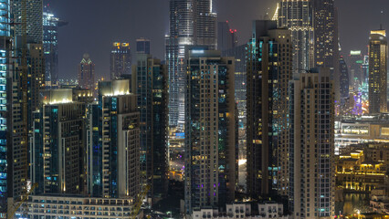 Aerial cityscape timelapse at night with illuminated modern architecture in Downtown of Dubai, United Arab Emirates.