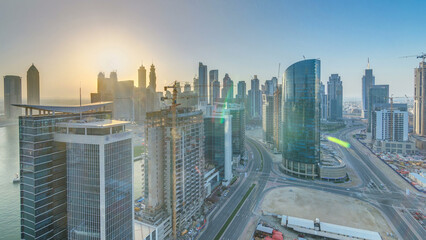 Dubai business bay towers at sunset aerial timelapse.