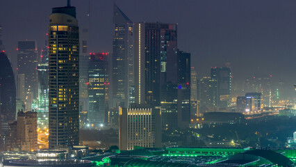 Dubai Downtown night to day timelapse. Aerial view over big futuristic city by night.