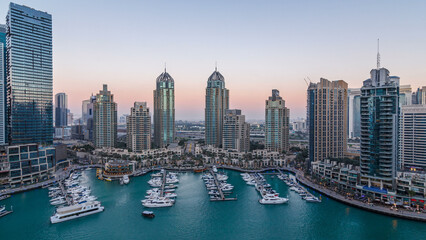 Dubai Marina skyscrapers aerial day to night timelapse, port with luxury yachts and marina promenade