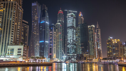 Fototapeta na wymiar Dubai marina bay with yachts an boats night timelapse