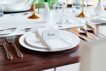 Exquisite Wedding Reception Table Setup with Groom's Place Card - obrazy, fototapety, plakaty