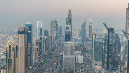 Scenic Dubai downtown skyline day to night timelapse. Rooftop view of Sheikh Zayed road