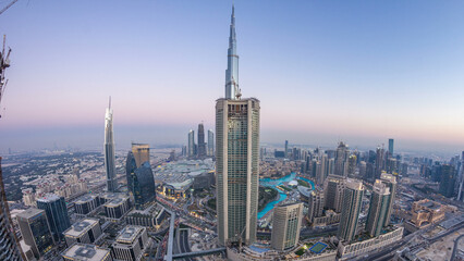Dubai Downtown day to night timelapse modern towers panoramic view from the top in Dubai, United Arab Emirates.