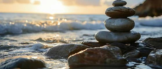 Outdoor kussens Against the backdrop of a serene sunset, harmonious stack of smooth pebbles of meditation and mindfulness, a symbol of balance and harmony with nature © Lidok_L