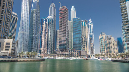 Panoramic view with modern skyscrapers and yachts of Dubai Marina timelapse, United Arab Emirates