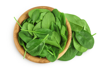 Baby spinach leaves in wooden bowl isolated on white background. Top view. Flat lay