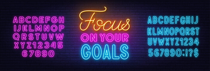 Focus on Your Goals neon lettering on brick wall background