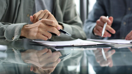 Working with documents and discussing at the desk in the office in close-up