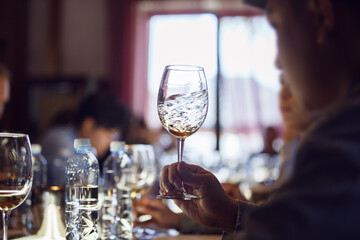 Man Swirling White Wine Glass at Sommelier School - 767112893