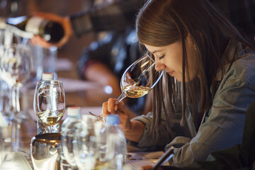 Woman Sitting at Table With Glass of Wine