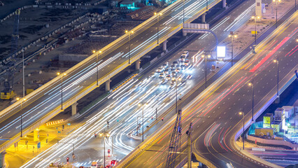Night traffic on a busy intersection at Dubai downtown highway aerial timelapse