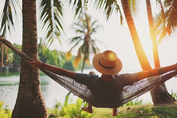 Person relaxing in a hammock between palm trees serene