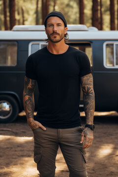 Male model posing outdoors with plain blank black canvas t-shirt mockup