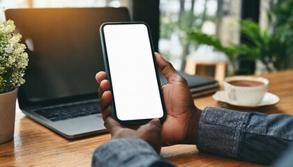 Mobile Phone for Mockup - Mobile Phone held by Hand at a desk or Cafe, at Home Environment - Template for Application Presentation