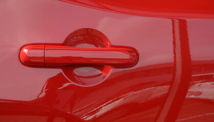 Red car door handle vivid color. Transportation industry concept  