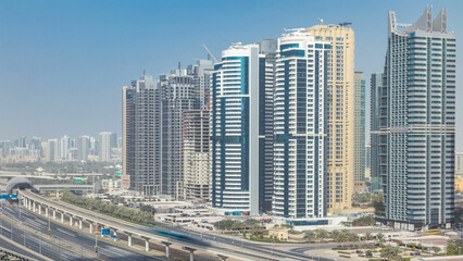 Fototapeta na wymiar Aerial view of Jumeirah lakes towers skyscrapers timelapse with traffic on sheikh zayed road.