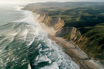 Aerial perspective of a sandy beach meeting rocky cliffs along the coast