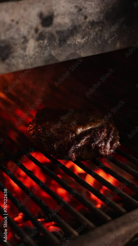 Wall mural Chef cooks steak on the grill