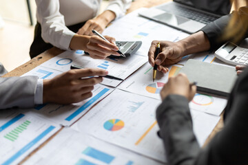 Meeting to discuss business consultants together analyzing financial information and planning investments.