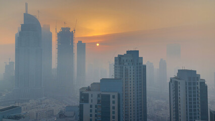 Foggy morning sunrise in downtown of Dubai timelapse.
