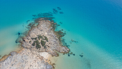 Aerial view of the Sardinian coast. Crystal clear sea of ​​Chia beach. Calm and sunny sea